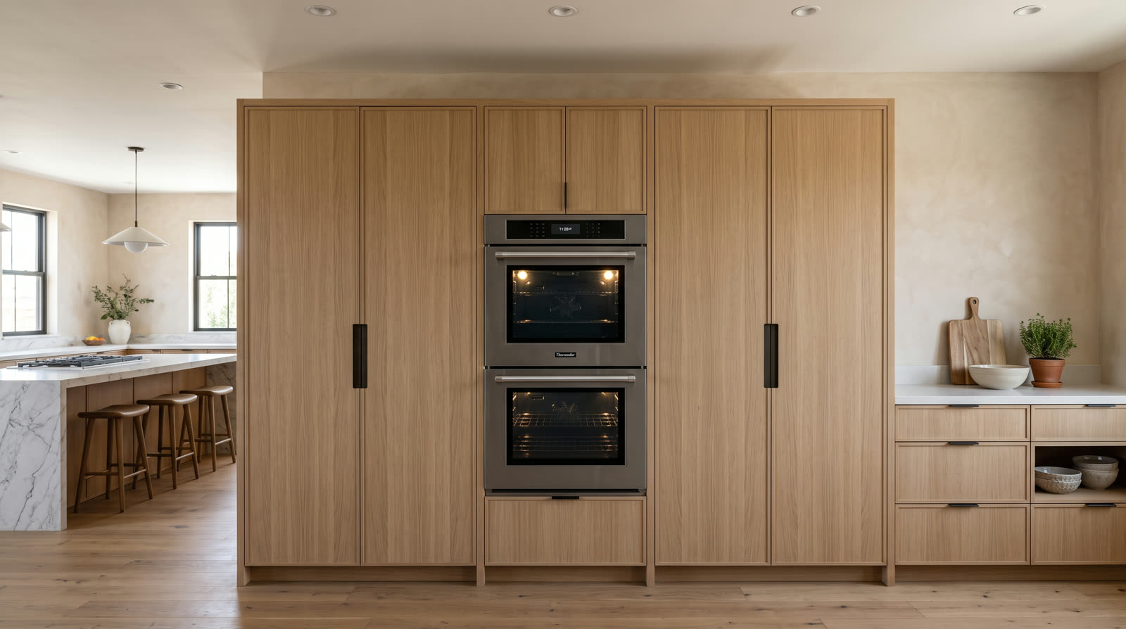 Thermador wall ovens centered in an oak cabinet wall